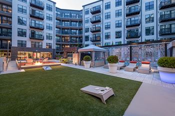 Courtyard lounge with lawn games and sunken fire pit