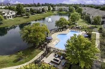 Walking trail surrounding lake with fountains