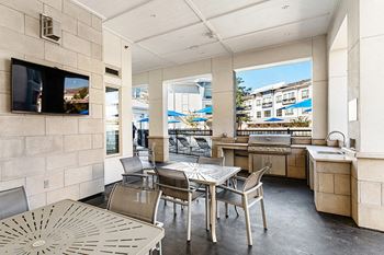 Bbq grills and outdoor seating area with nearby fire pit