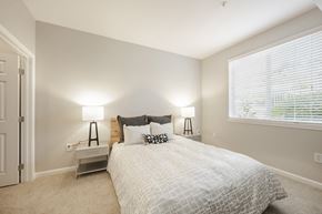 Renton apartment for rent - a bedroom with a bed and a large window