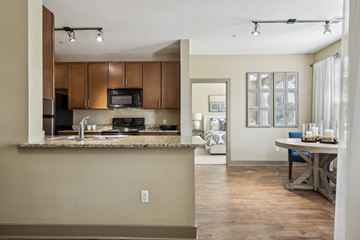 Aurora apartment for rent - A kitchen with brown cabinets and a granite countertop.