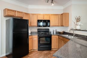 Kansas City apartment for rent - Carrington Place at Shoal Creek - Gourmet kitchen with black appliances