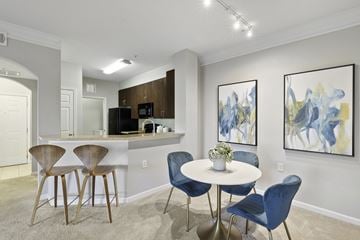 Pooler apartment for rent - A dining area with a white table and blue chairs.