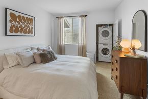 Redlands apartment for rent - A bedroom with a large bed and a wooden nightstand.