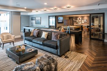 Expansive club room with kitchen and dining area, lounge seating, fireplace and tvs