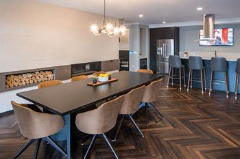 Expansive club room with kitchen and dining area, lounge seating, fireplace and tvs