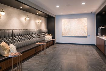 Expansive club room with kitchen and dining area, lounge seating, fireplace and tvs