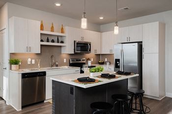 Stainless steel appliance package with water and ice dispenser in refrigerator