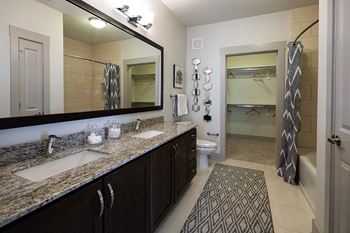 Spacious walk-in closets with wood shelving