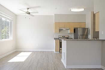 Wood-style flooring throughout living areas and carpet in the bedrooms*