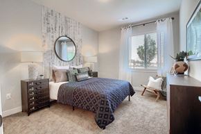 Arvada apartment for rent - a bedroom with a bed and a window