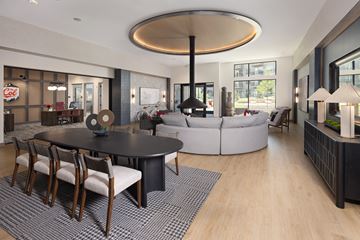 Golden apartment for rent - A modern living room with a black table and chairs.