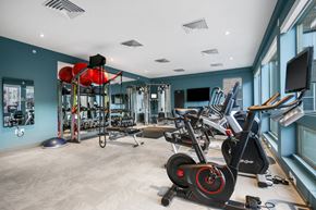 Golden apartment for rent - A gym with a variety of exercise equipment including stationary bikes and weight racks.