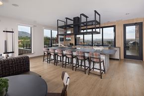 Golden apartment for rent - A modern kitchen with a dining table and chairs.