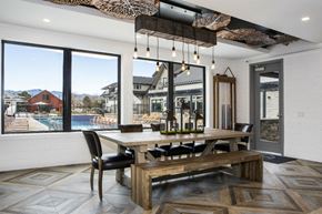 Arvada apartment for rent - a dining room with a table and chairs and a view of a swimming pool