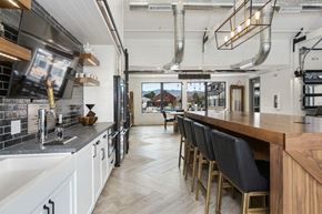 Arvada apartment for rent - a kitchen with a long counter and a bar with chairs
