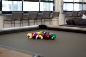 Arvada apartment for rent - a pool table with a bunch of billiard balls on it