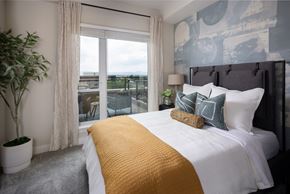 Englewood apartment for rent - A bedroom with a large bed and a view of the city.