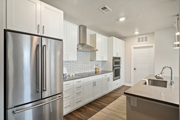 Castle Rock apartment for rent - A modern kitchen with a stainless steel refrigerator and white cabinets.
