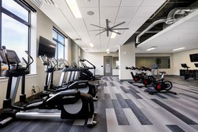 Castle Rock apartment for rent - a gym with cardio equipment and weights on the floor