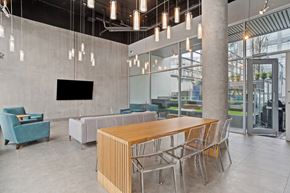 Vancouver apartment for rent - a communal table and chairs in a lobby of a building
