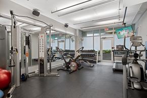 Vancouver apartment for rent - a gym with weights and cardio equipment on the floor and windows