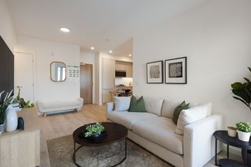 Richmond apartment for rent - A living room with a white couch and a coffee table.