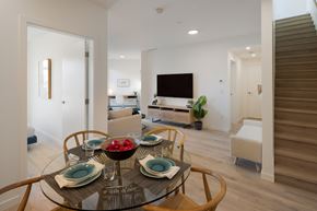 Richmond apartment for rent - A modern dining room with a glass table set for four.