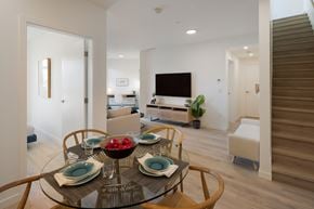 Richmond apartment for rent - A modern dining room with a glass table set for four.