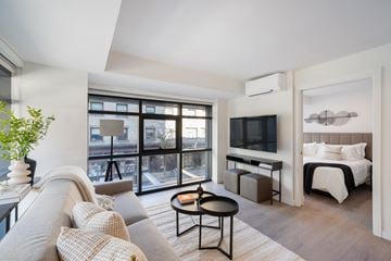 Vancouver apartment for rent - A living room with a grey couch and a black coffee table.