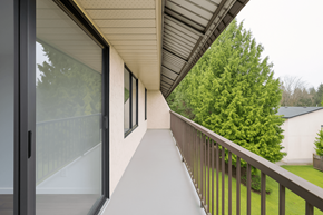 Abbotsford apartment for rent - A balcony with a railing and a view of a green tree.