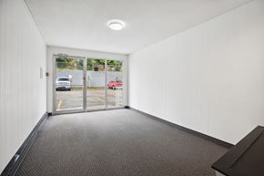 Abbotsford apartment for rent - A hallway with a car parked outside the window.