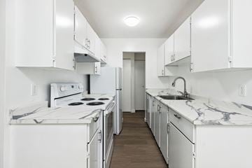 New Westminster apartment for rent - A white kitchen with a marble counter top.