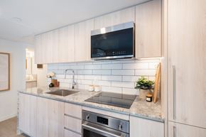 Vancouver apartment for rent - A modern kitchen with a stainless steel sink and oven.