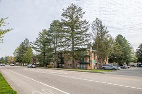 Surrey apartment for rent - A street with a bike lane and a building in the background.