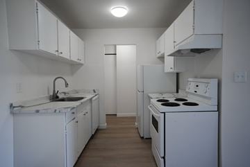 New Westminster apartment for rent - A kitchen with white appliances and cabinets.