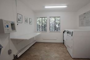 Chilliwack apartment for rent - A medical room with a bed, a window, and a wall of paperwork.