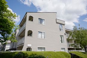 Abbotsford apartment for rent - A modern building with a curved facade and multiple windows.
