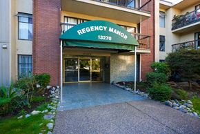 Surrey apartment for rent - The front of the Regency Manor building with a green awning.
