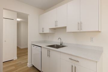 Surrey apartment for rent - A kitchen with white cabinets and a white sink.
