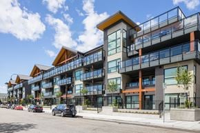 North Vancouver apartment for rent - a large apartment building with cars parked in front of it