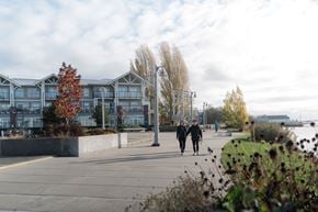 Richmond apartment for rent - Two people walking a dog on a sidewalk.