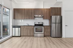 Vancouver apartment for rent - A modern kitchen with wooden cabinets and stainless steel appliances.