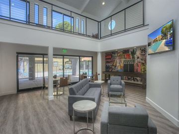 Phoenix apartment for rent - A living room with grey couches and a television on the wall.