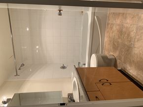 Surrey apartment for rent - A bathroom with a walk-in shower and a wooden counter.