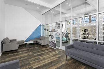 Phoenix apartment for rent - A modern living room with a grey couch and a blue accent wall.