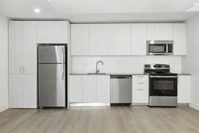 Mesa apartment for rent - A modern kitchen with stainless steel appliances and white cabinets. at Central on Broadway Apartments, Arizona, 85202