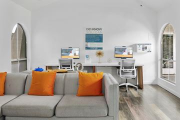Mesa apartment for rent - A living room with a grey couch and orange pillows.