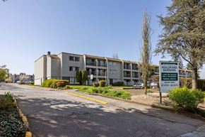 Surrey apartment for rent - A street view of a building with a sign that reads Guildford Gardens.