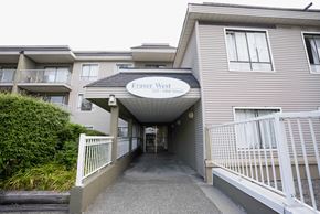 New Westminster apartment for rent - The entrance to Fraser West Apartments is covered by a white awning.
